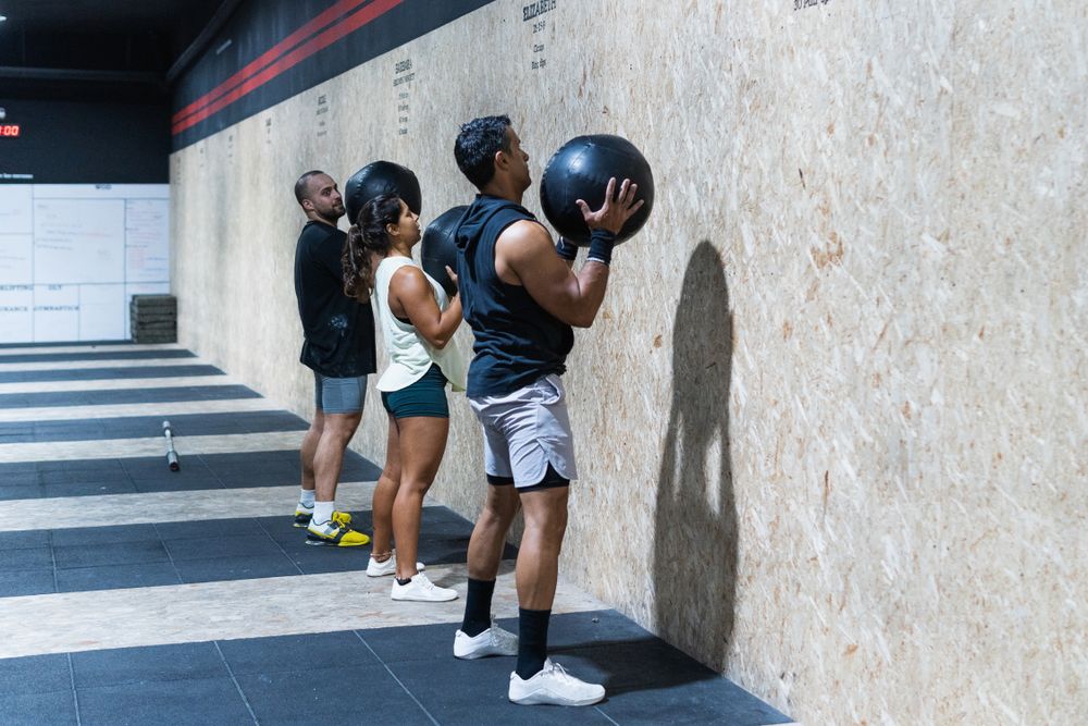Hispanic sportspeople training with medical balls