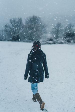 Woman walking on winter field