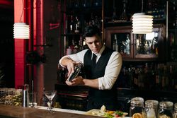 Barman working mixing drinks in a shaker
