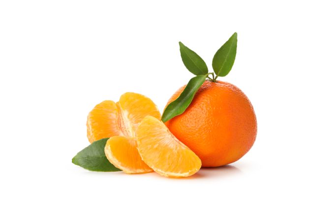 Ripe mandarin with leaves isolated on light background