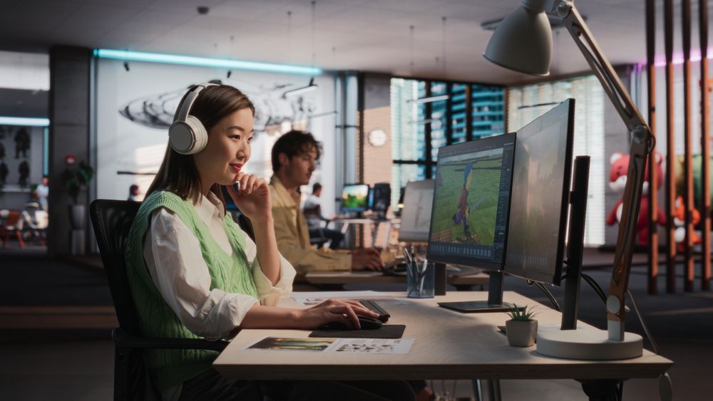 Female Asian Game Designer Using Desktop Computer, Designing Unique World And Characters In 3D modelling