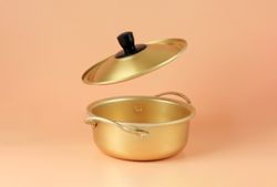 Brass pot in studio with open lid