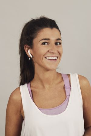 Female athlete listening to music in studio