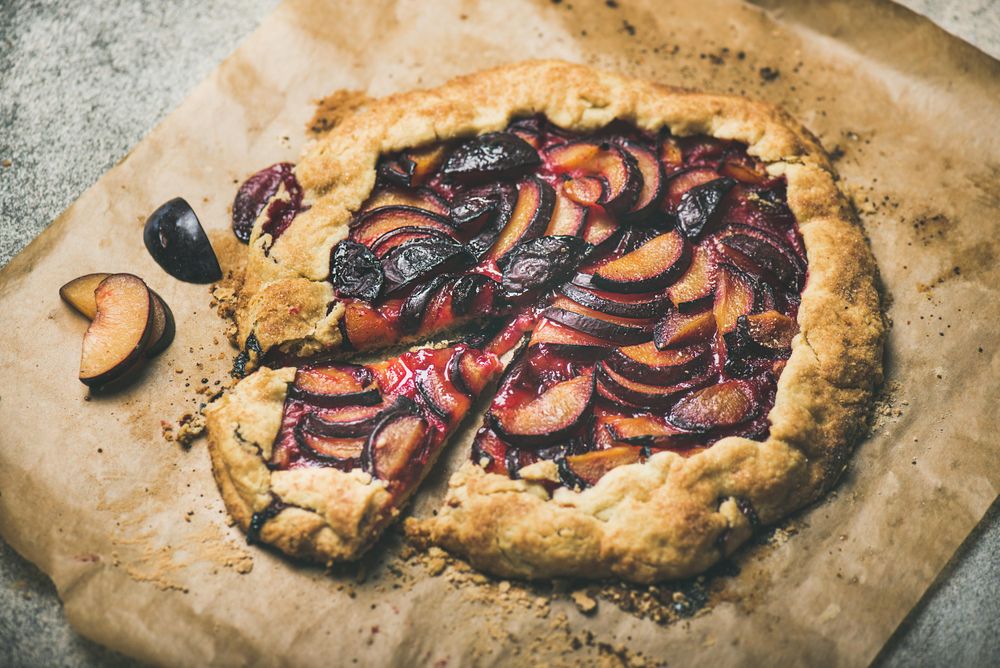 Whole fruit tart on parchment paper, close up