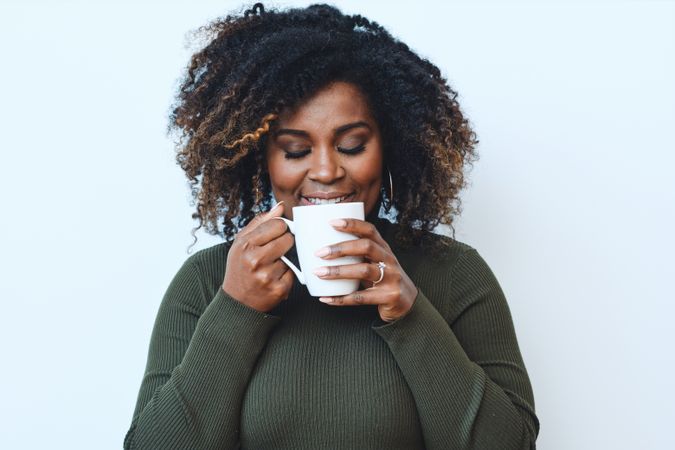 Black woman relaxing with cup of coffee