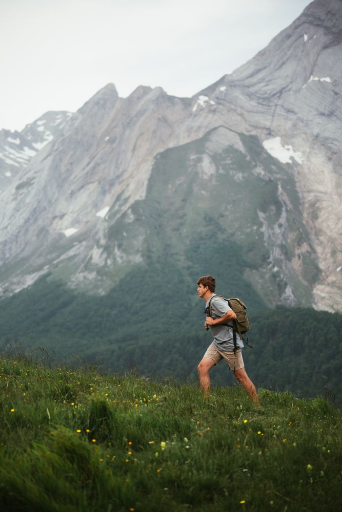 Unrecognizable man with backpack hiking in Pyrenees mountains