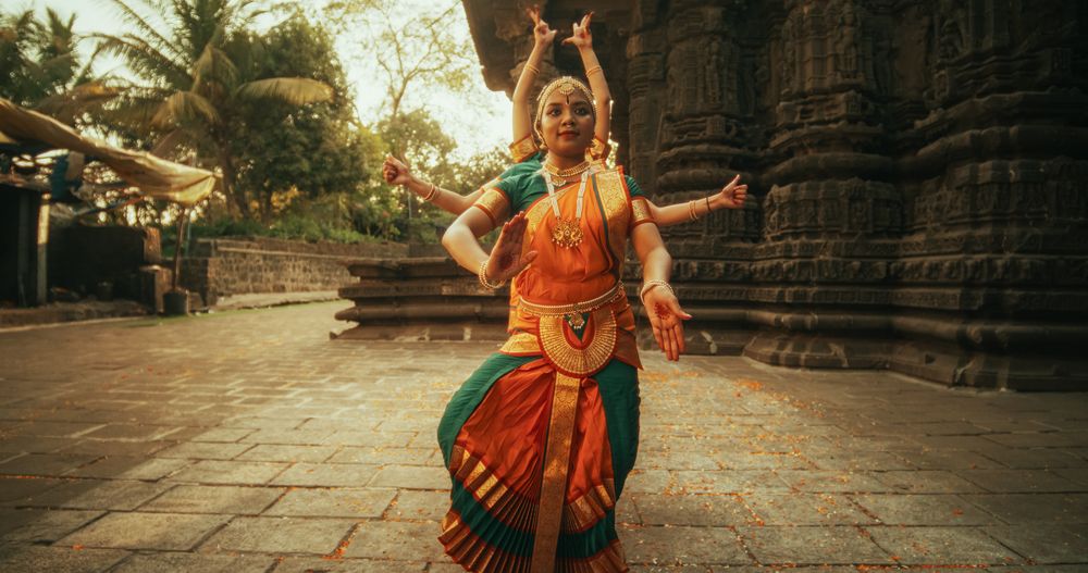 Portrait of Indian Women in Traditional Clothes Dancing Bharatanatyam in Colourful Sari.
