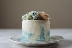 Buttercream flowers cake, blue and pastel peach colors
