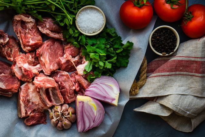 Raw meat, onion, tomatoes and cilantro ready to cook