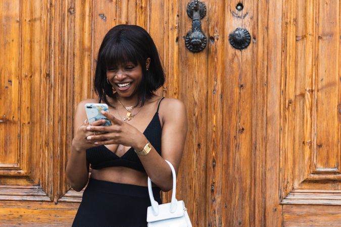 Black woman chatting on smartphone