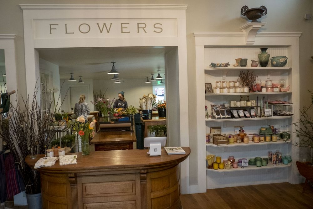Copake, New York - May 19, 2022: Woman arranging flowers in gift shop