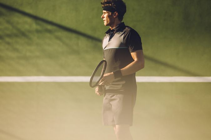 Tennis player playing on a club hard court