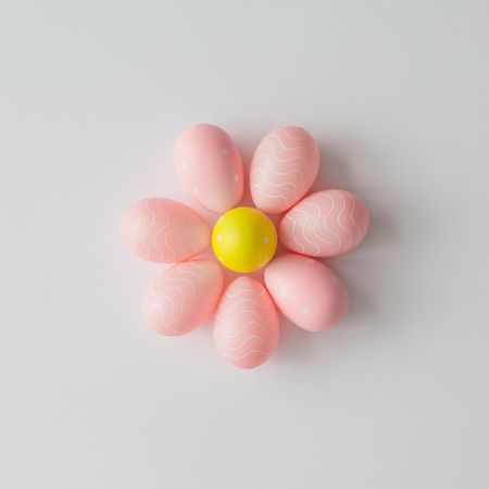 Pastel Easter eggs in shape of flower on light background