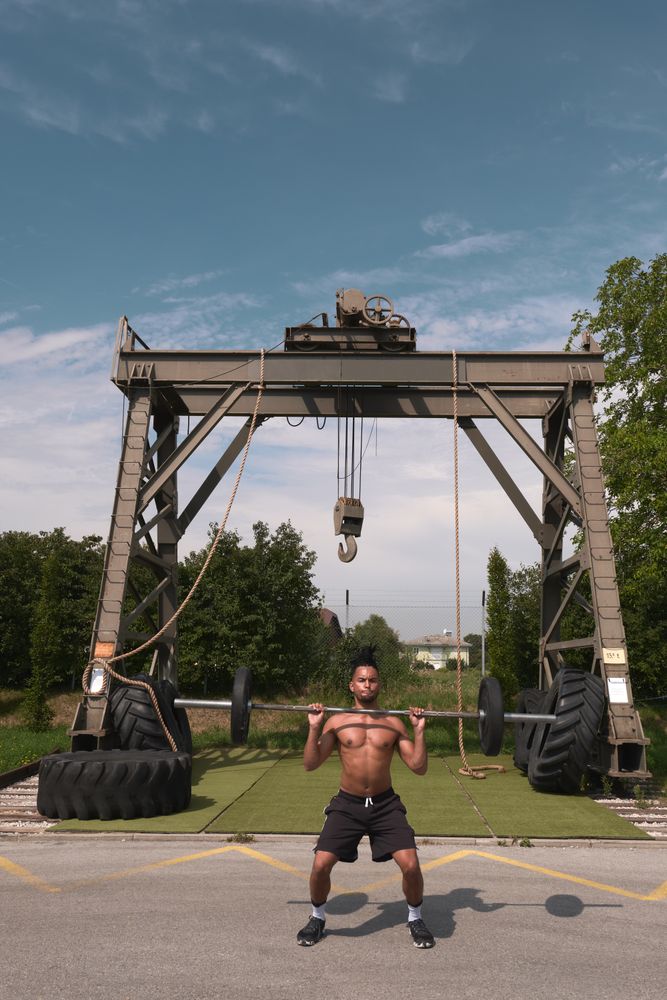 Black guy with barbell in outdoor gym