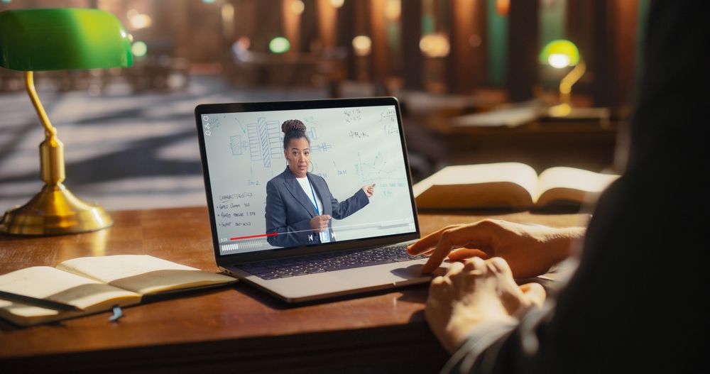 Student Learning From Online Lecture on Laptop in Library