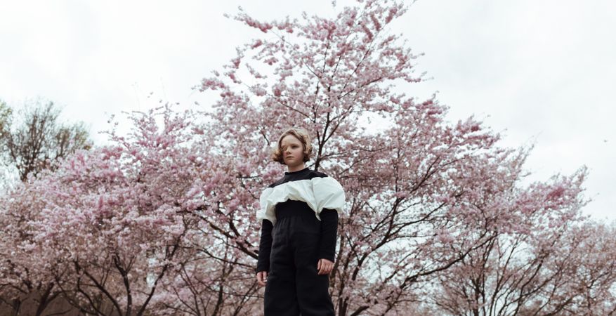 Girl standing near blooming tree