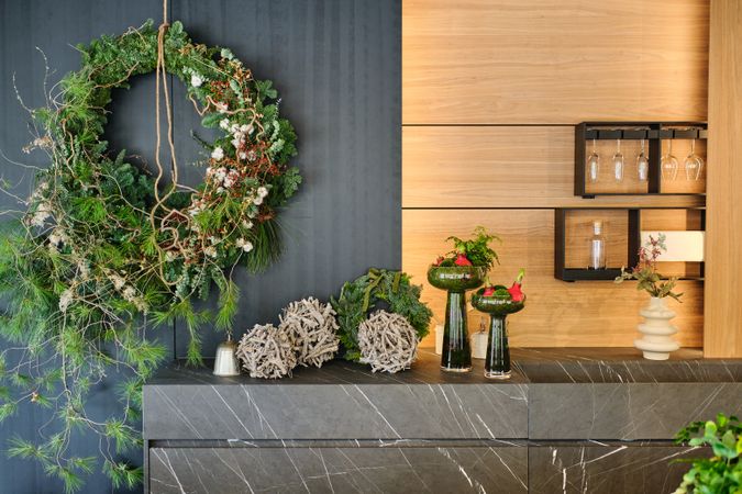 Floristry studio interior with wreath and potted flowers