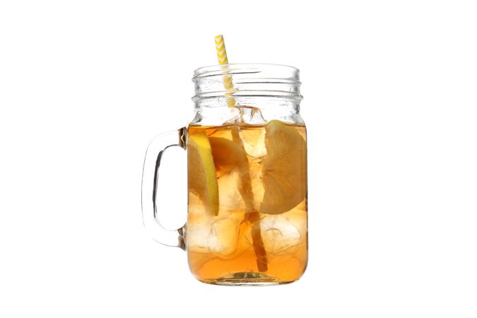 A glass of cold tea with an orange, isolated on plain background