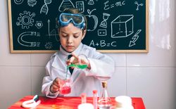 Serious kid playing with science set