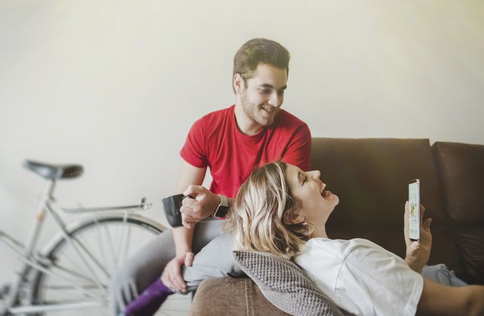 Couple on sofa on the mobile phone