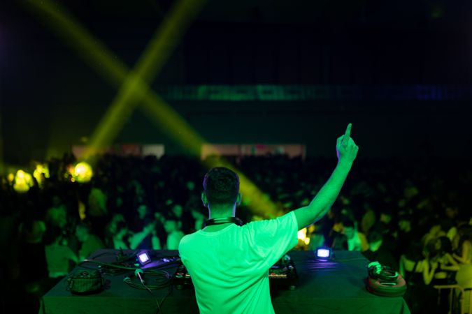DJ gesturing during a performance in a club