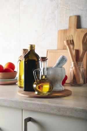 Kitchen table with different supplies and bottles with oil