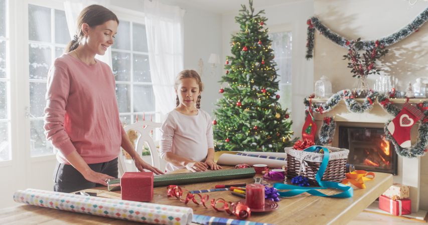 Cute Little Girl Choosing Decorations for Gift Boxes to Give to Family, Holiday Season Full of Love and Sharing