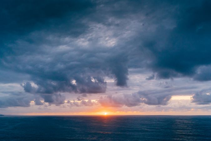 Grassy shore near stormy sea in evening