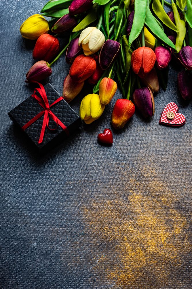 Top view of counter with tulips and giftbox 