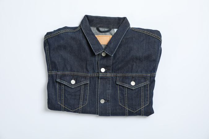 Denim jacket on light background, space for text