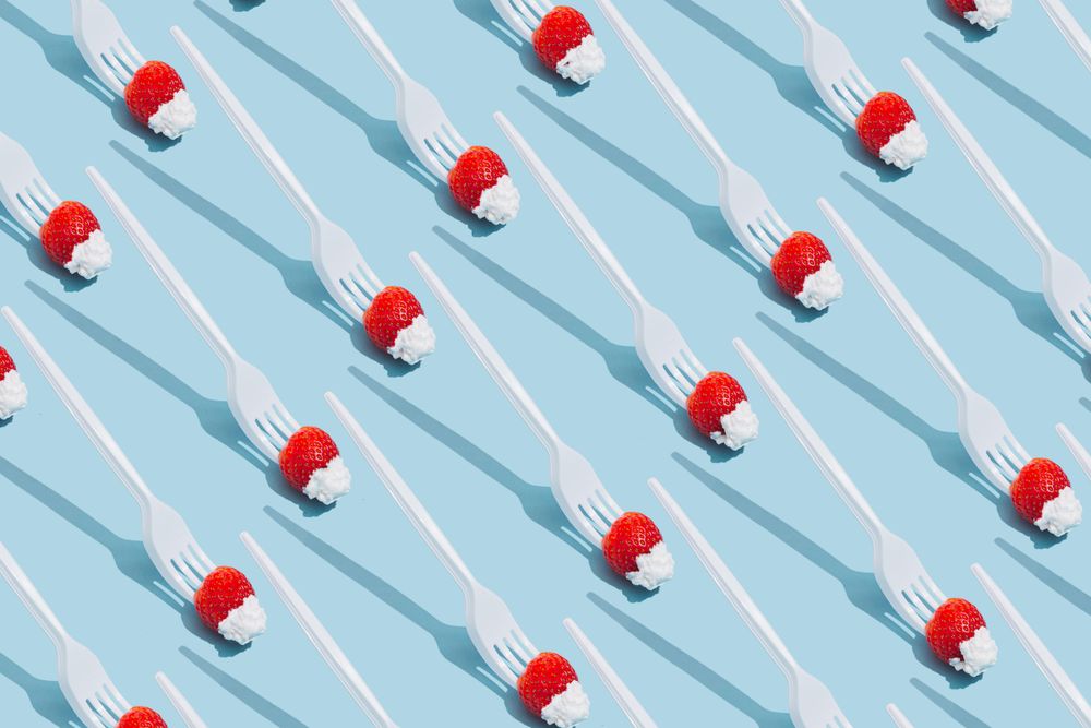 Pattern of forks holding strawberries