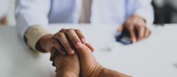 Hands on a doctor’s desk