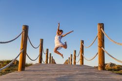 Woman posing in air on footbridge