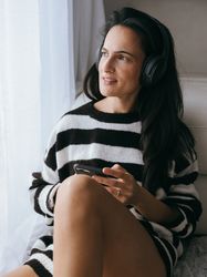 Woman listening to music in bedroom