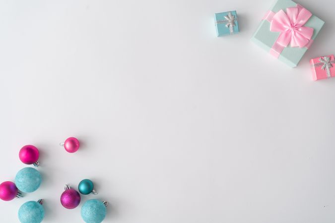 Christmas decorations and gifts on corners of light background