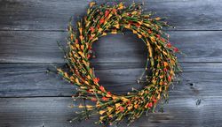 Autumn wreath with small orange flowers for the season