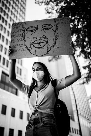 MONTREAL, QUEBEC, CANADA – June 7 2020- Woman holding a sign during a black lives matter march