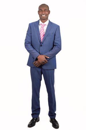 Smiling male in business attire standing tall with blank background