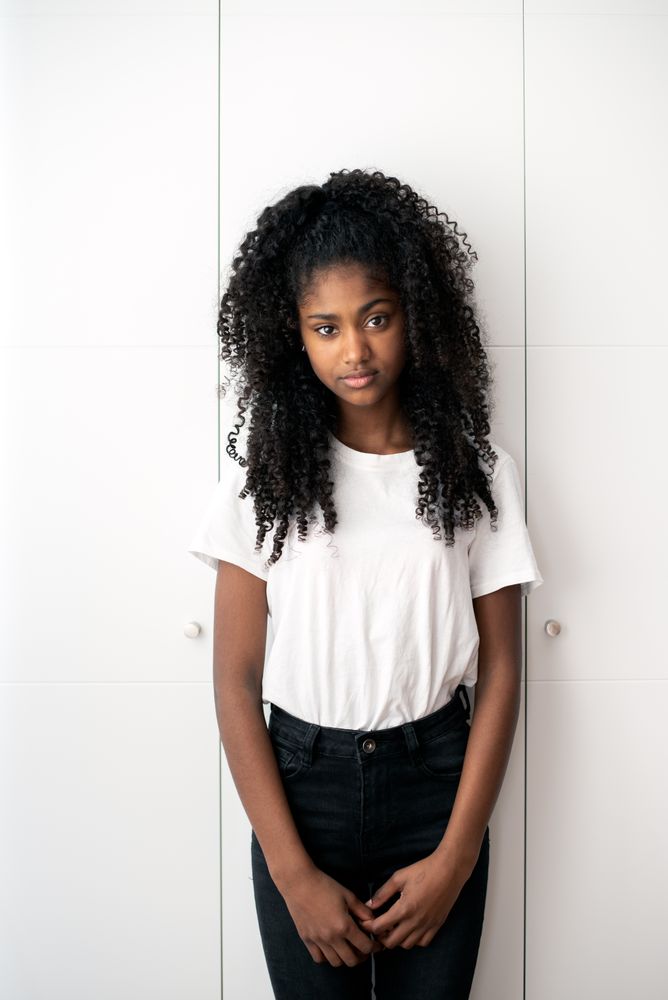 Portrait of a beautiful young Black teenage girl looking into camera