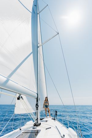 Woman in swimsuit standing on boat