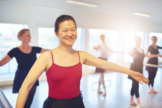 Portrait of smiling Asian woman at ballet class