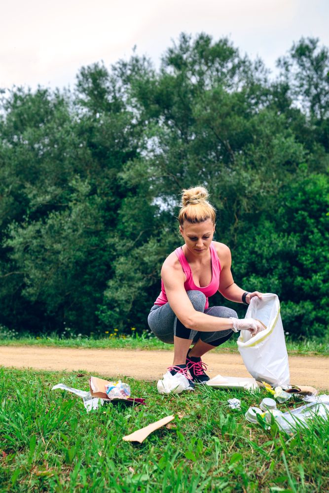 Woman picking up trash doing plogging