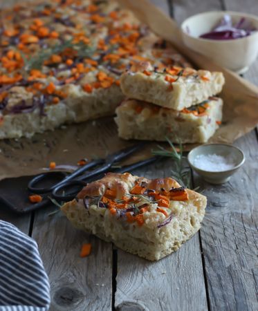 Pieces of fresh focaccia on wooden table