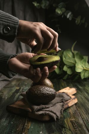 Person hands holding avocados