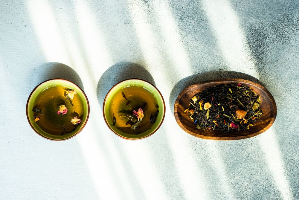 Top view of tea time concept with green tea and chopsticks