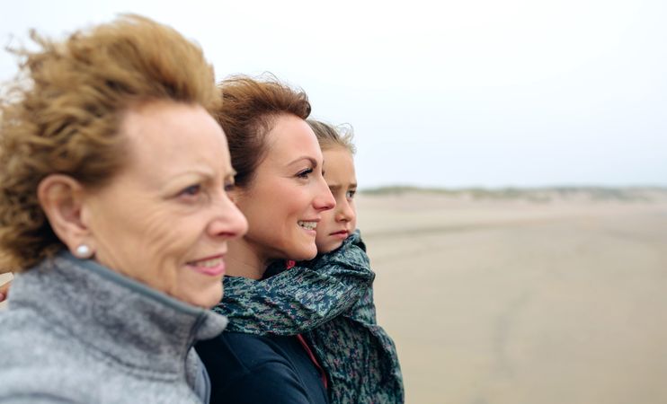 Three generations of females looking at sea