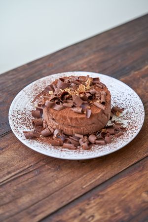 Delicious chocolate cake on wooden table