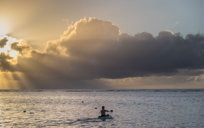 Person kayaking at dusk