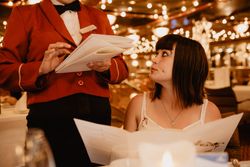 Female customer making order in restaurant