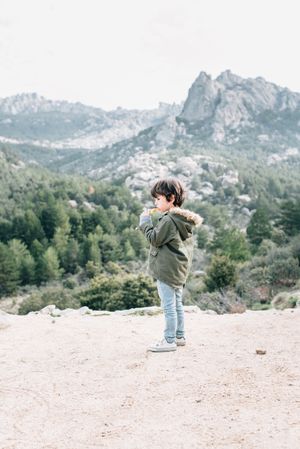 Boy walking on rocky hill